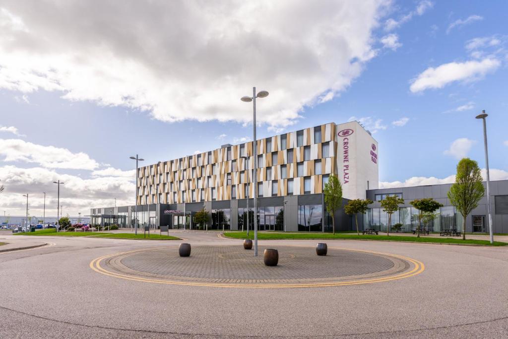 a large building with a roundabout in front of it at Crowne Plaza Aberdeen Airport by IHG in Dyce