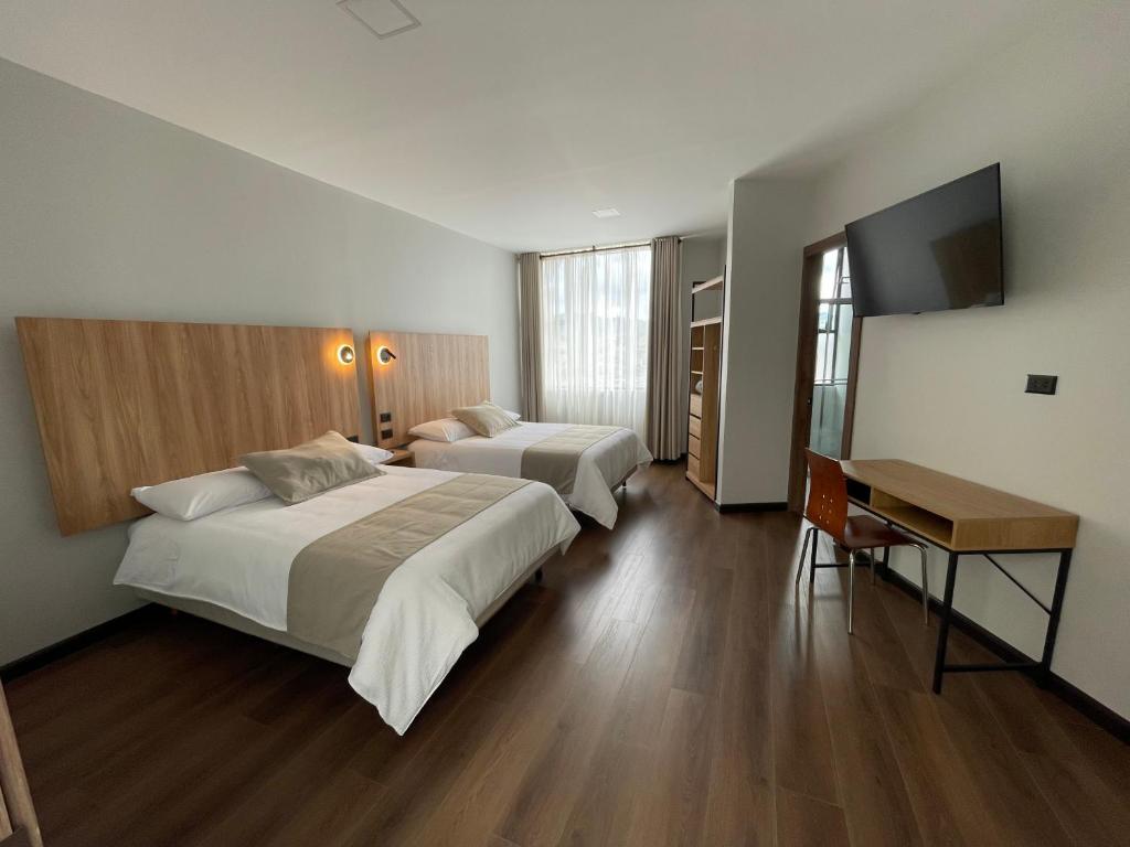Postel nebo postele na pokoji v ubytování Universitario Hotel