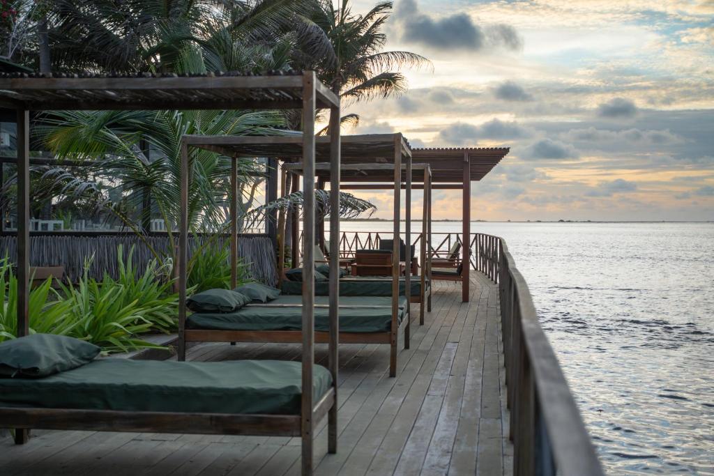 a row of beds on a pier near the water at Santa Maria Atins in Atins