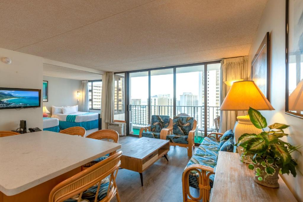 a living room with a couch and a table at Spacious & Affordable Waikiki Getaway - Perfect for Families & Groups, Near Beach includes Free Parking (22208) in Honolulu