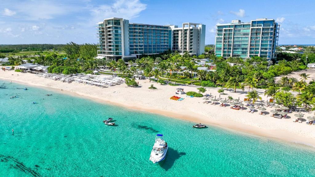 an aerial view of a beach with a boat in the water at Kimpton Seafire Resort + Spa by IHG in West Bay