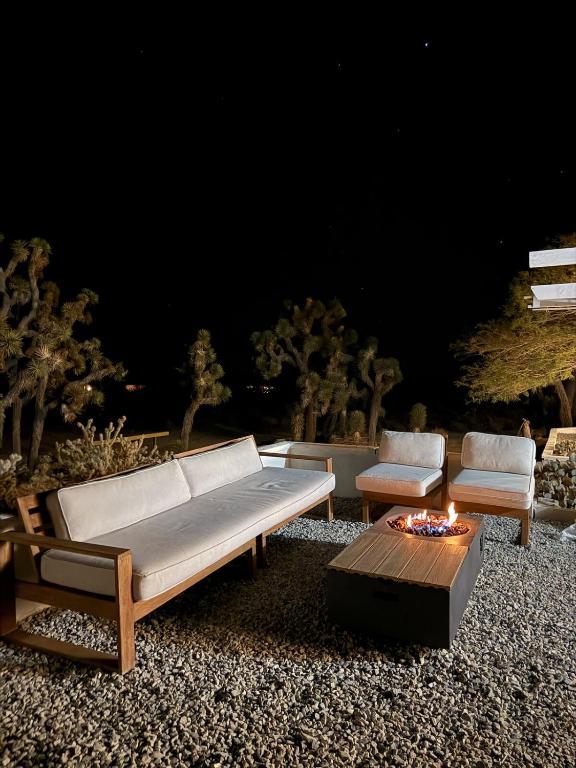 a couch and two chairs and a coffee table at Casa Nova Romantic Desert Escape in Yucca Valley