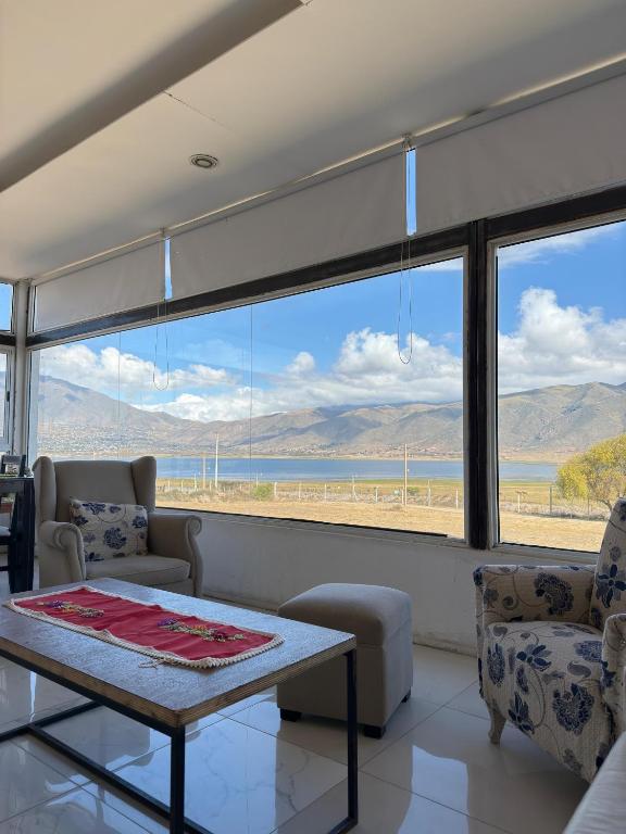 a living room with a table and a view of the ocean at Sueño de Tafi in Tafí del Valle