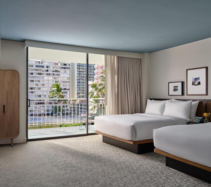 Postel nebo postele na pokoji v ubytování Romer House Waikiki