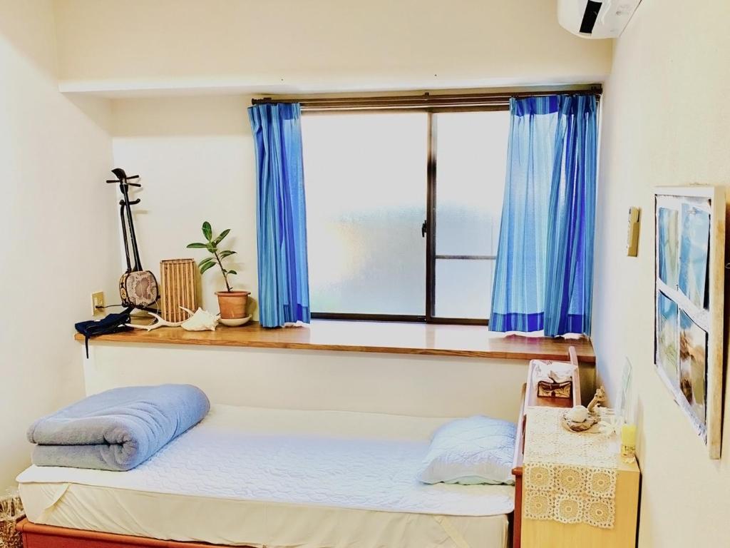 Postel nebo postele na pokoji v ubytování Guesthouse IKETA