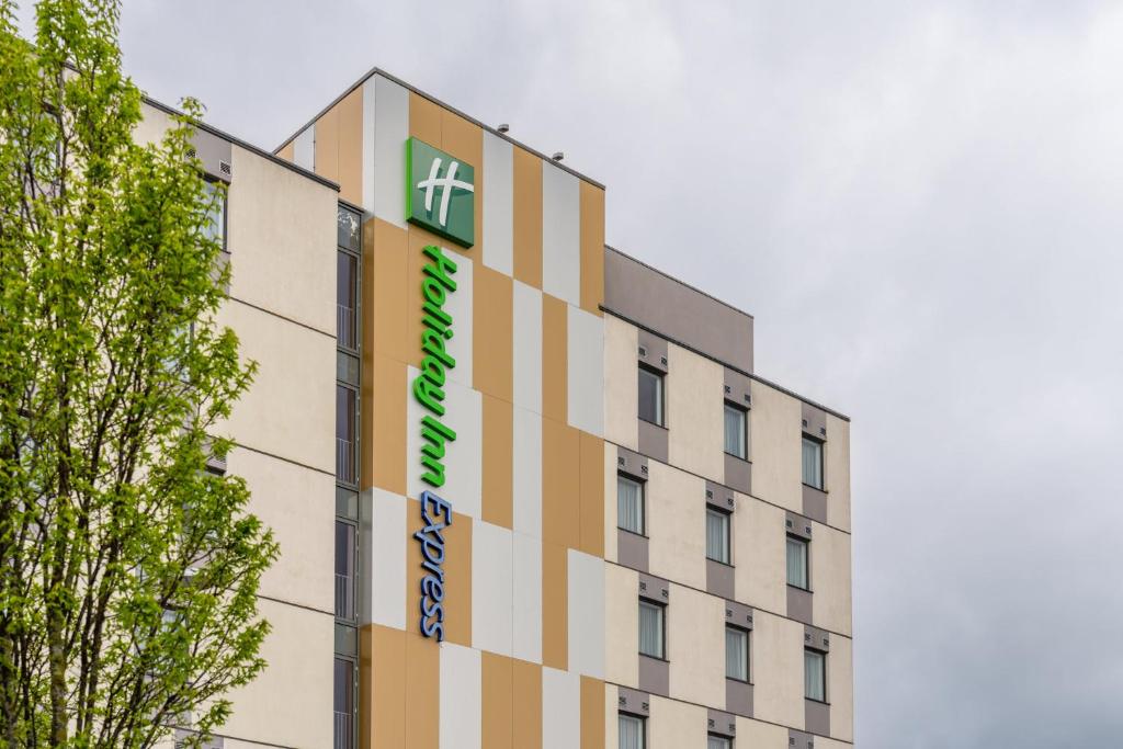 a building with a sign on the side of it at Holiday Inn Express Aberdeen Airport by IHG in Dyce