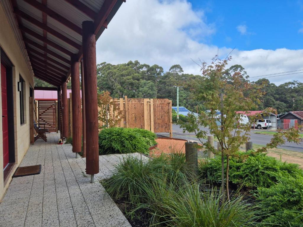 a porch of a building with a fence in the background at Pemberton Japanese Garden Studio 2025 Winner Travellers Award in Pemberton