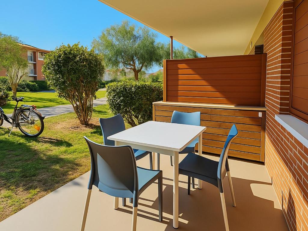 une table et des chaises sur le patio d'une maison dans l'établissement Appartement F2 avec terrasse, jardin, parking et accès piscine à 500m du village d'Argelès-sur-Mer - FR-1-732-63, à Argelès-sur-Mer