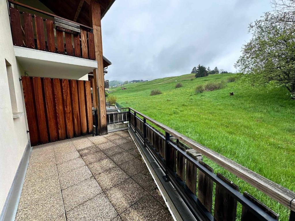 a porch of a house with a view of a field at Villard Village - Appartement 6 pers, 35 m² - FR-1-515-226 in Villard-de-Lans