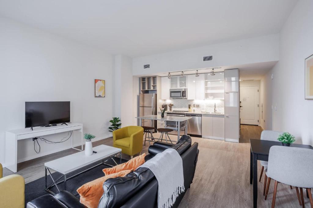 a living room with a couch and a table at CozySuites Sky Central #7 in Cincinnati