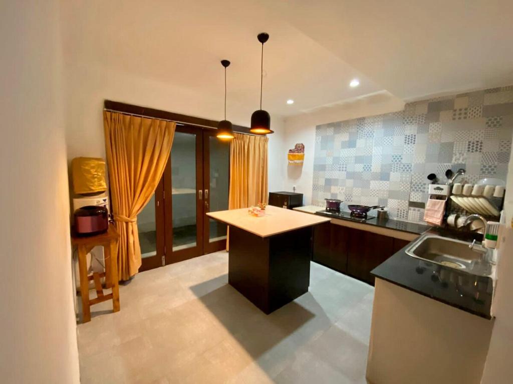 a kitchen with a sink and a counter top at Djanuraga House 6 in Darmasaba