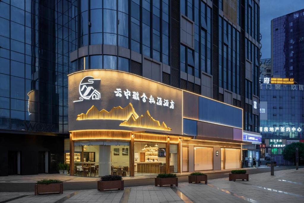 Un edificio con un cartel en el costado. en Leshan Yunzhong Yashe Private Hot Spring Hotel, en Leshan
