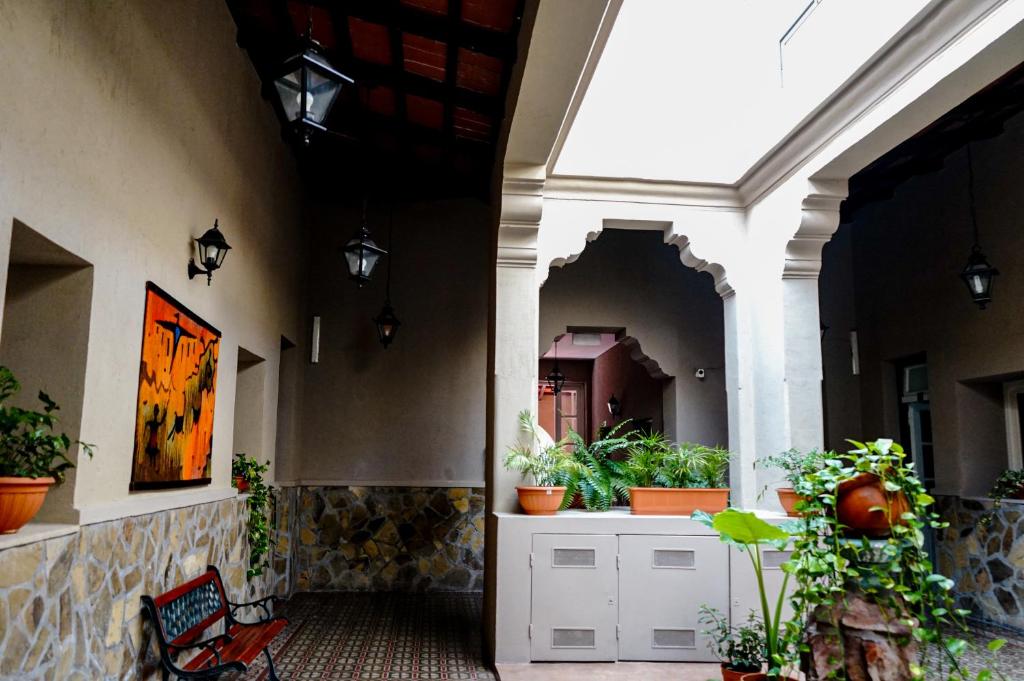 an entrance to a building with potted plants at Hotel de la Linda in Salta