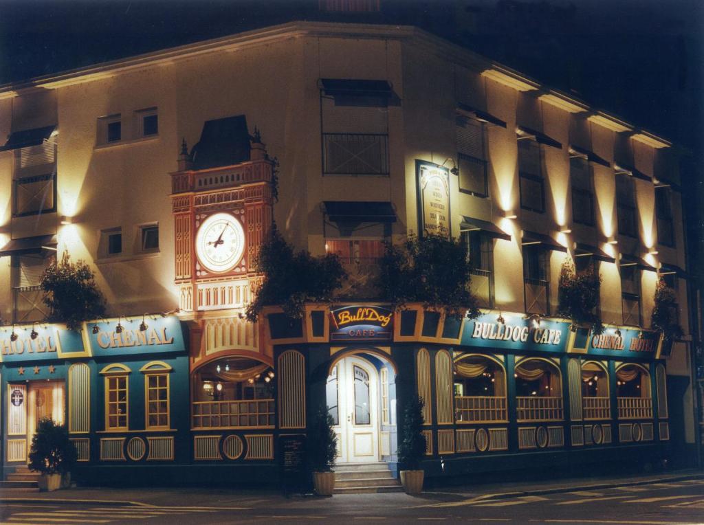 a building with a clock tower on the side of it at Chenal Hotel in Beauvais