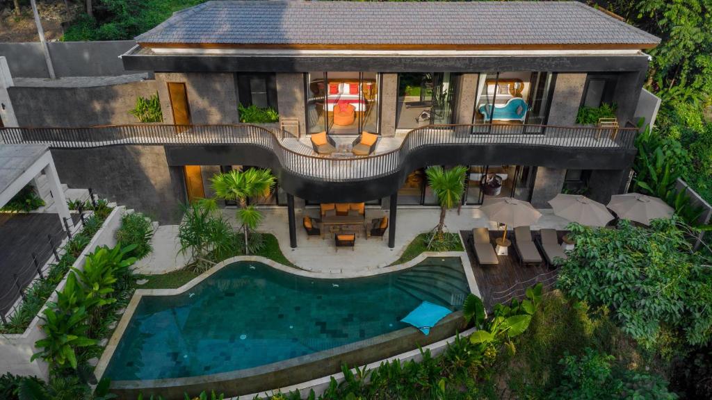 an aerial view of a house with a swimming pool at Villa Gayatri Sindu by BaliSuperHost in Ubud