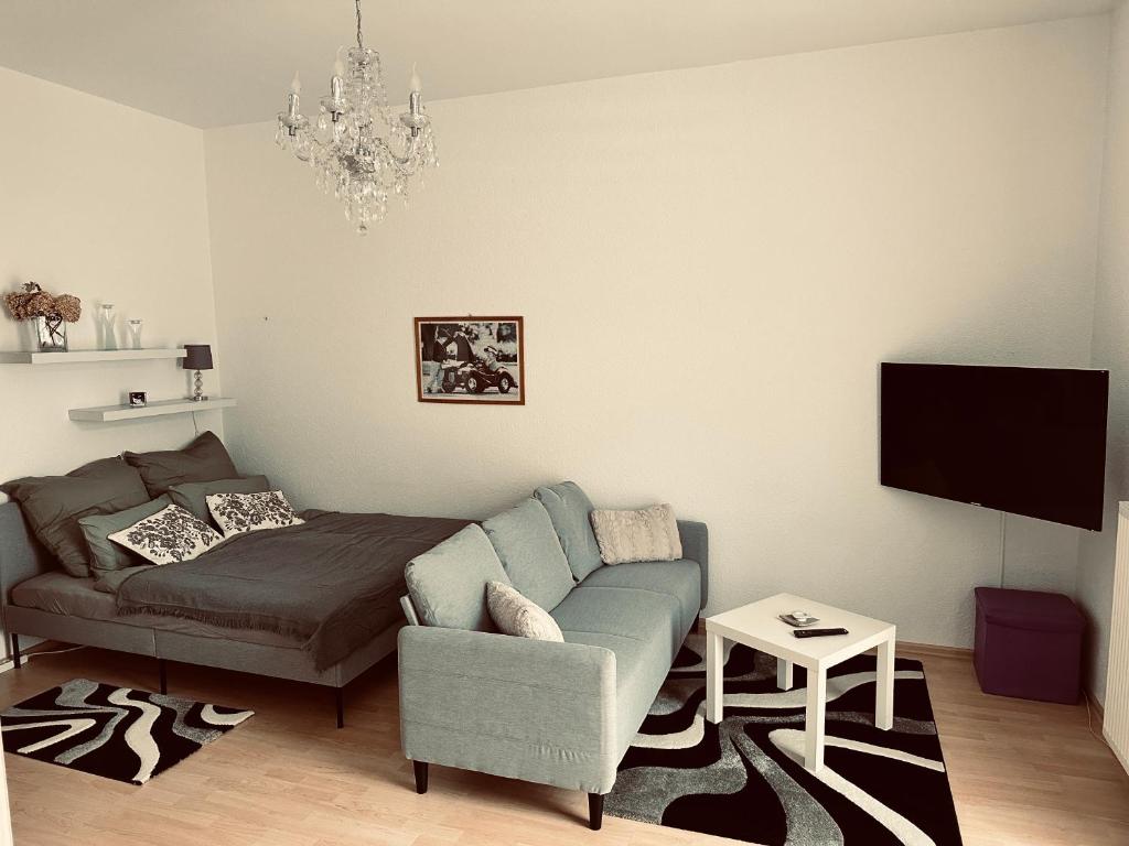 a living room with a couch and a tv at DG City-Apartment in Spremberg