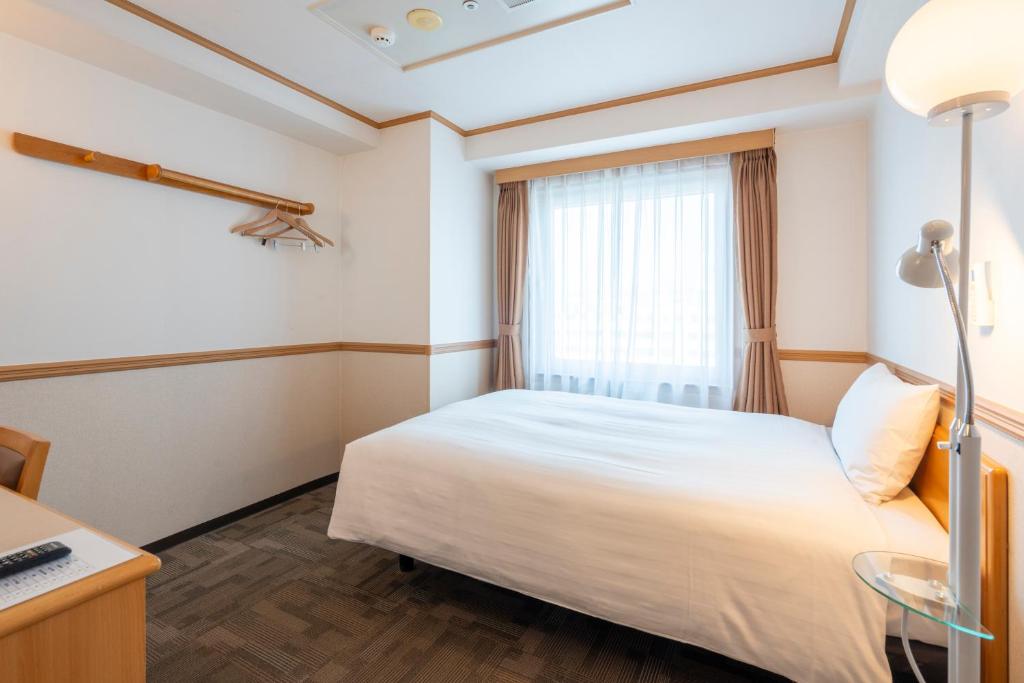 Postel nebo postele na pokoji v ubytování Toyoko Inn Daejeon Government Complex