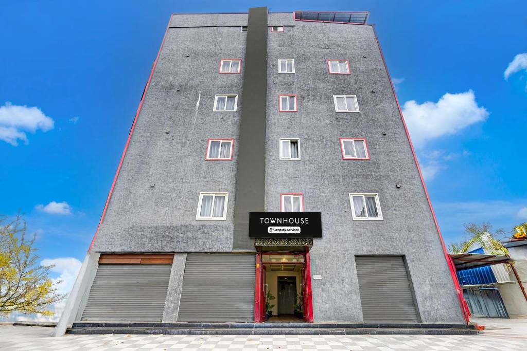 a tall gray building with a sign on it at Super Townhouse Tirupati in Tirupati