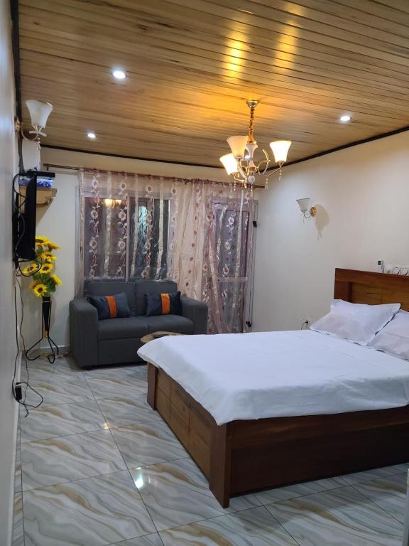 Appartement Ndjongue tesisinde bir odada yatak veya yataklar