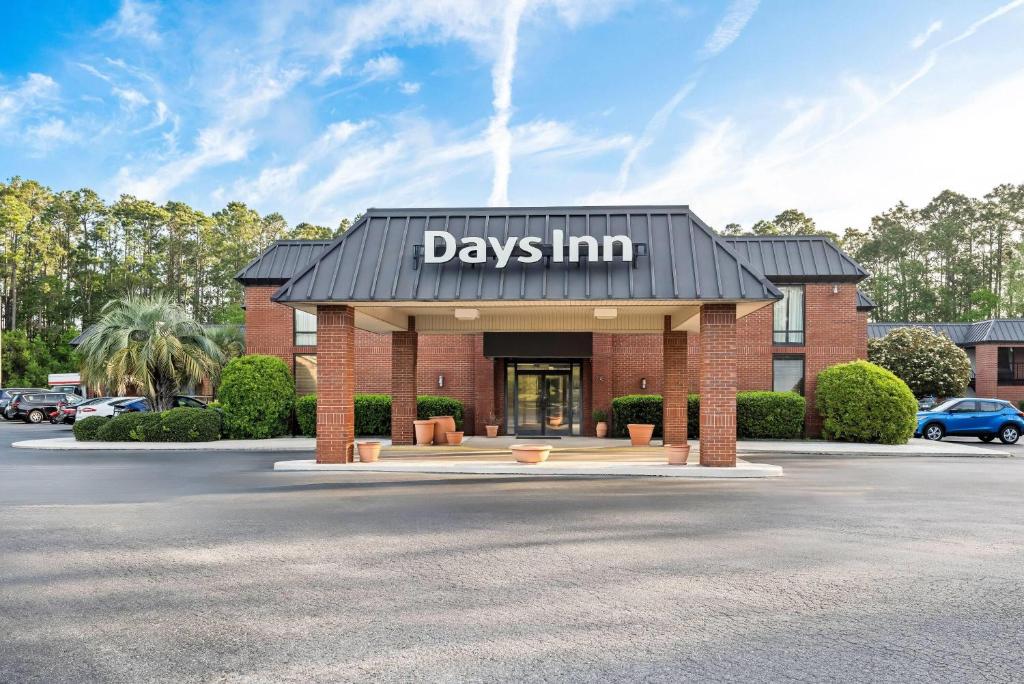 a day inn sign on the front of a building at Days Inn by Wyndham Statesboro in Statesboro