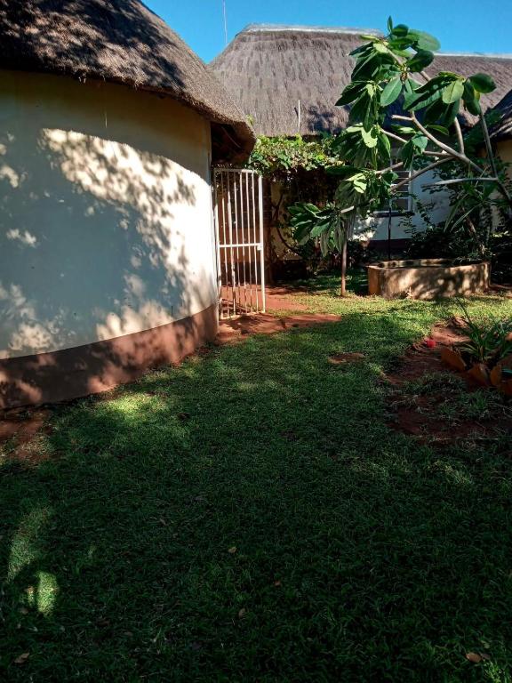 a house with a grass yard with a gate and a fence at Sabali in Rietfontein