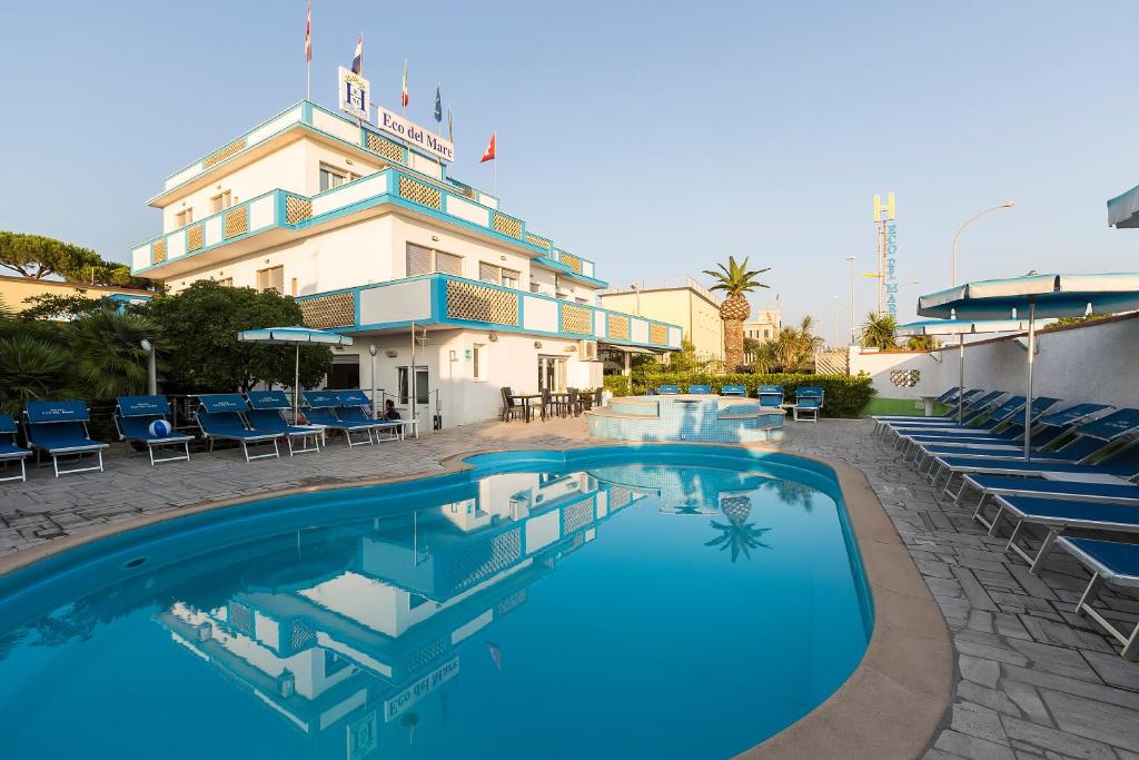 a large swimming pool in front of a hotel at Hotel Eco Del Mare in Marina di Massa