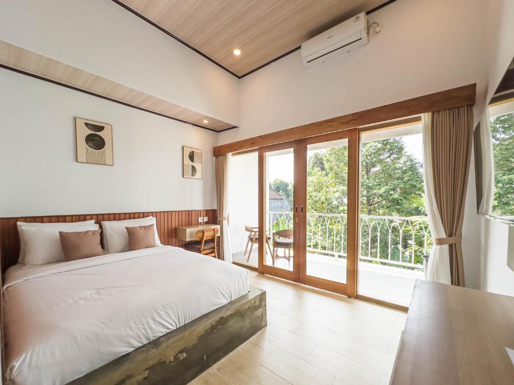 una camera da letto con un letto e un balcone di Tenkangin Homestay ad Ubud