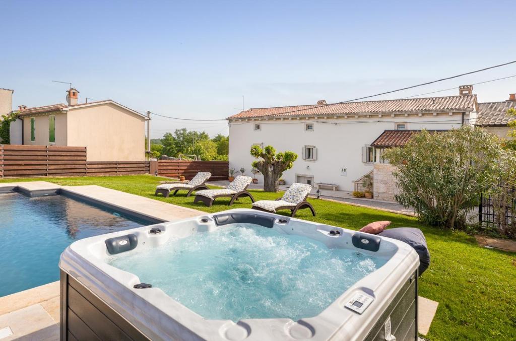 a hot tub in the backyard of a house at Villa Jona in Žužići