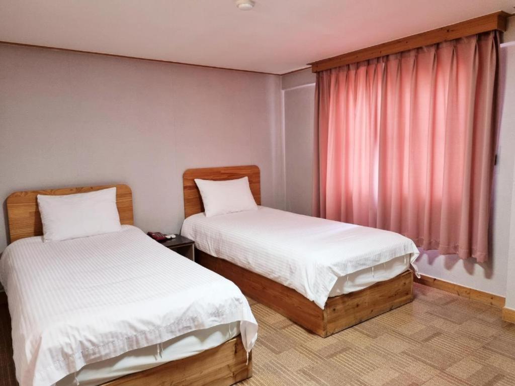 Postel nebo postele na pokoji v ubytování Hotel G