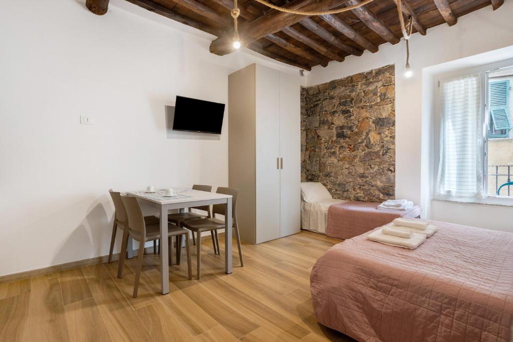 a bedroom with a bed and a table and chairs at Matt House in La Spezia