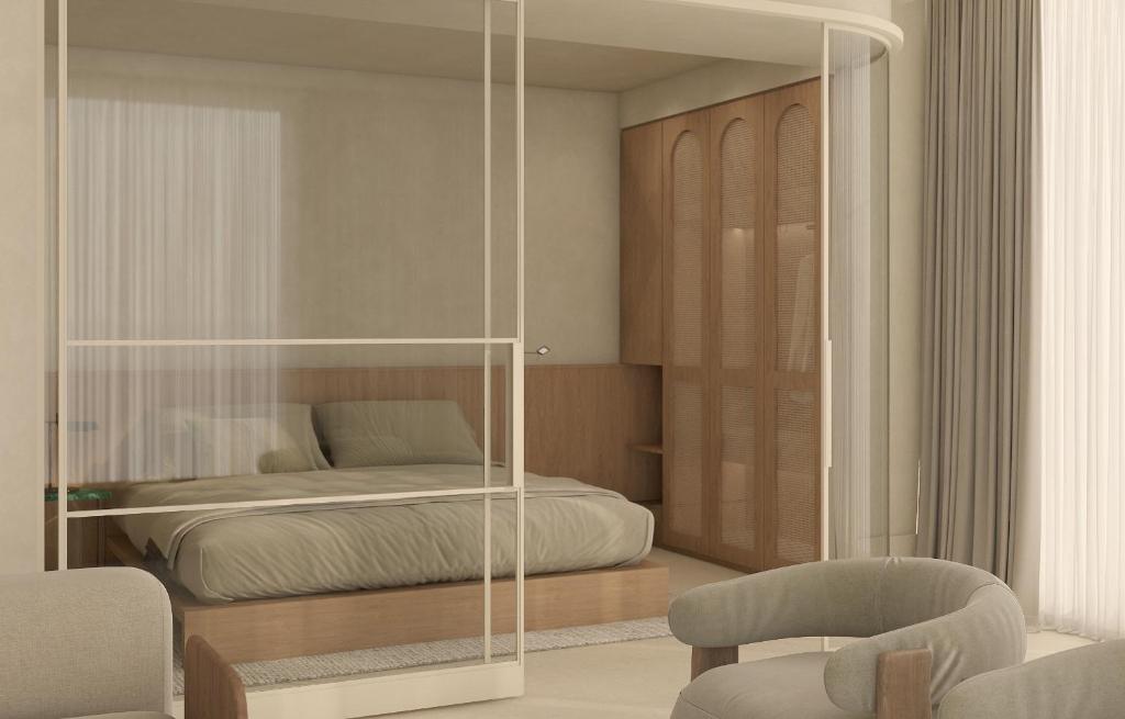 a bedroom with a bed and a glass wall at Infinity Hotel & More in Budva