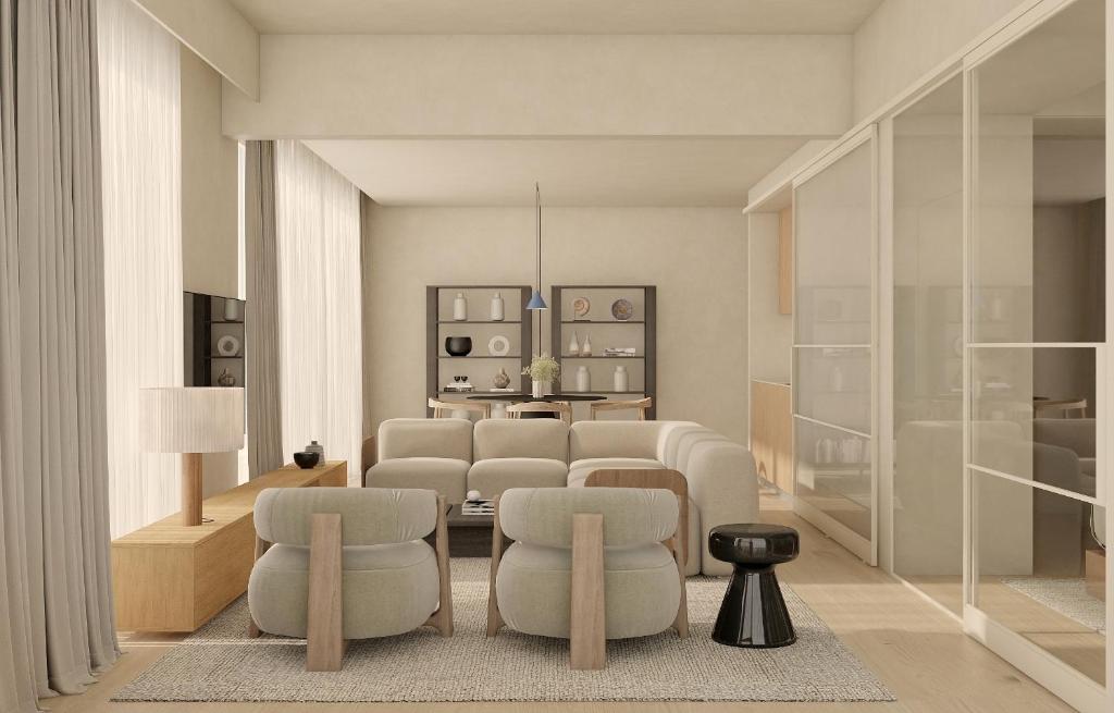 a living room with white chairs and a table at Infinity Hotel & More in Budva