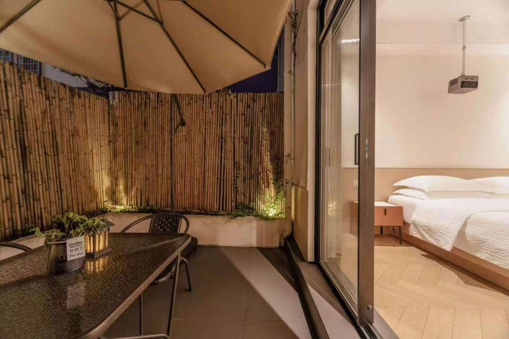 a hotel room with a bed and a table and a bed sidx sidx at Flower Whisperer Homestay Tianmenshan Store free airport and station pick-up in Zhangjiajie