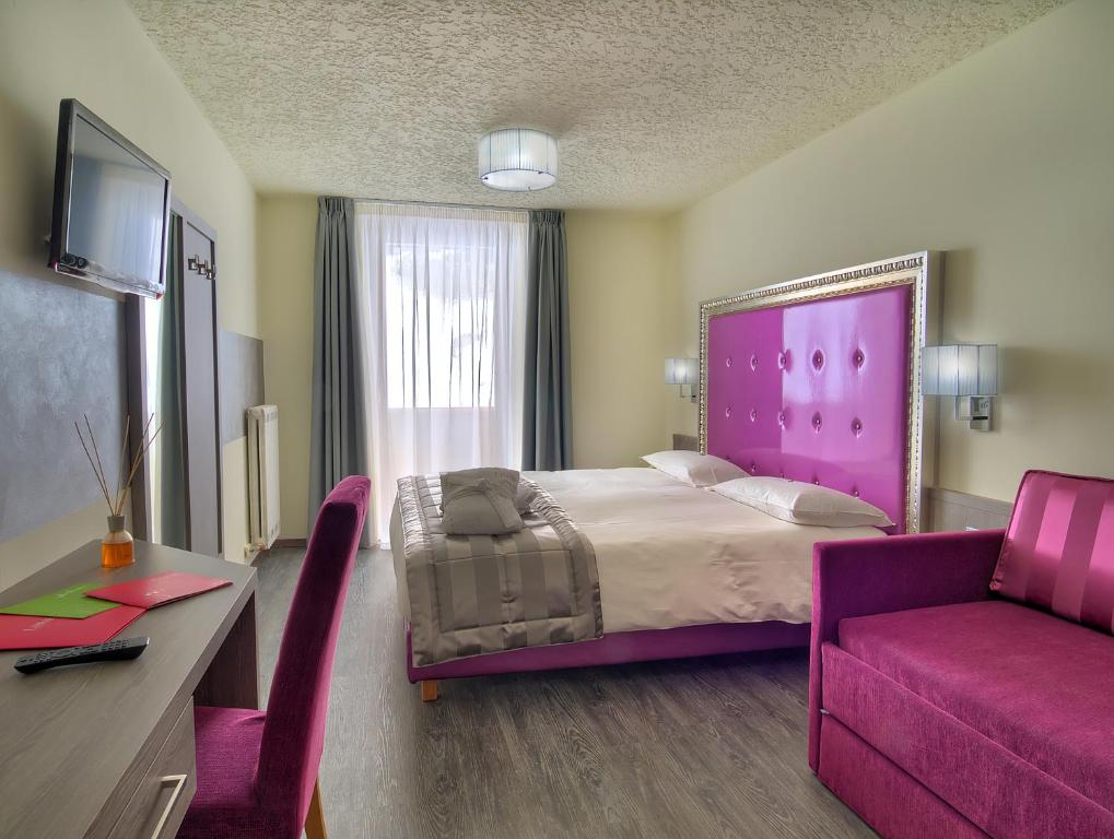 Postel nebo postele na pokoji v ubytování Luna Wellness Hotel