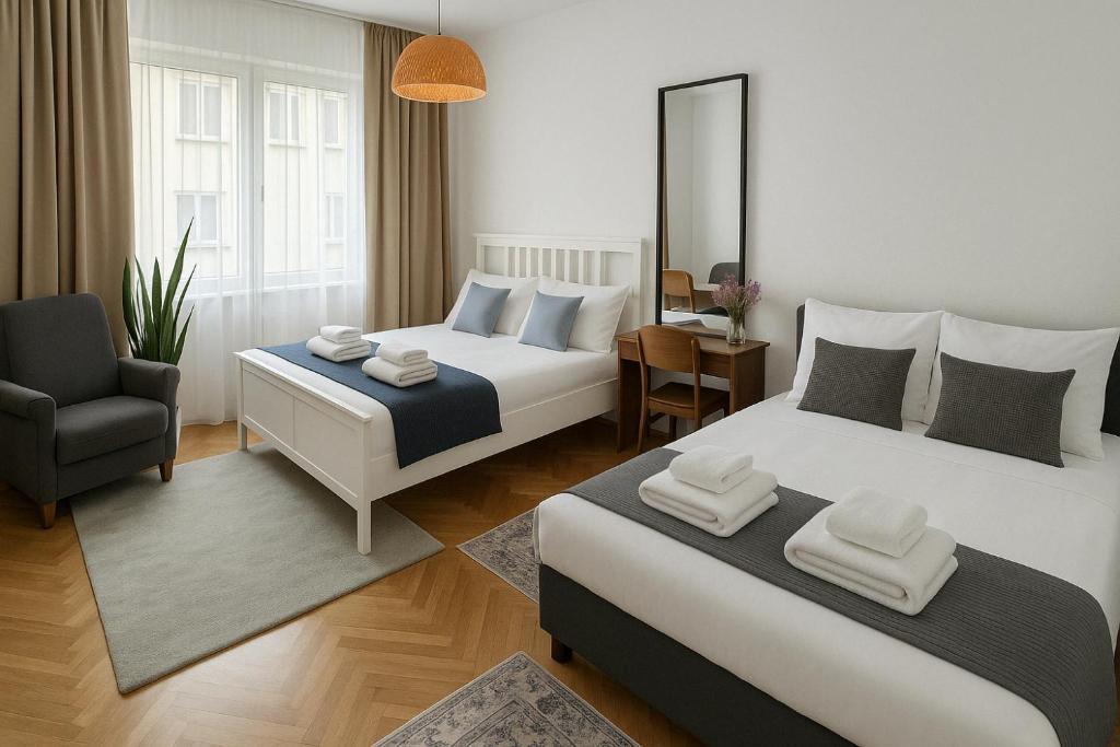 a hotel room with two beds and a chair at HelloZagreb Apartment in Zagreb