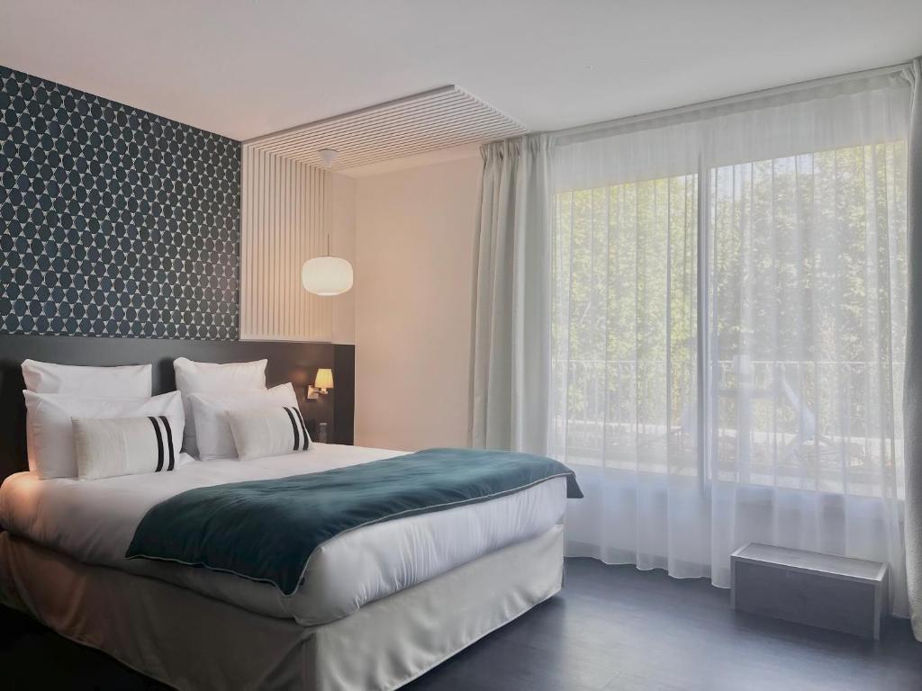 Postel nebo postele na pokoji v ubytování Le Prose Hôtel