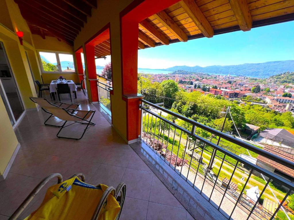 a balcony with chairs and a view of a city at Penthouse Valentino in Intra