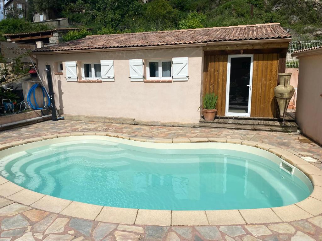 a swimming pool in a yard with a house at Casa Versini in Balogna