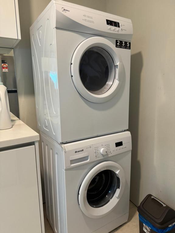 a washing machine and a dryer in a kitchen at Vortex Suites Klcc 2bedroom & 3bedroom apartment in Kuala Lumpur
