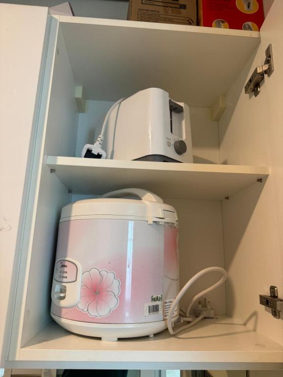 a toaster sitting on a shelf in a refrigerator at Vortex Suites Klcc 2bedroom & 3bedroom apartment in Kuala Lumpur