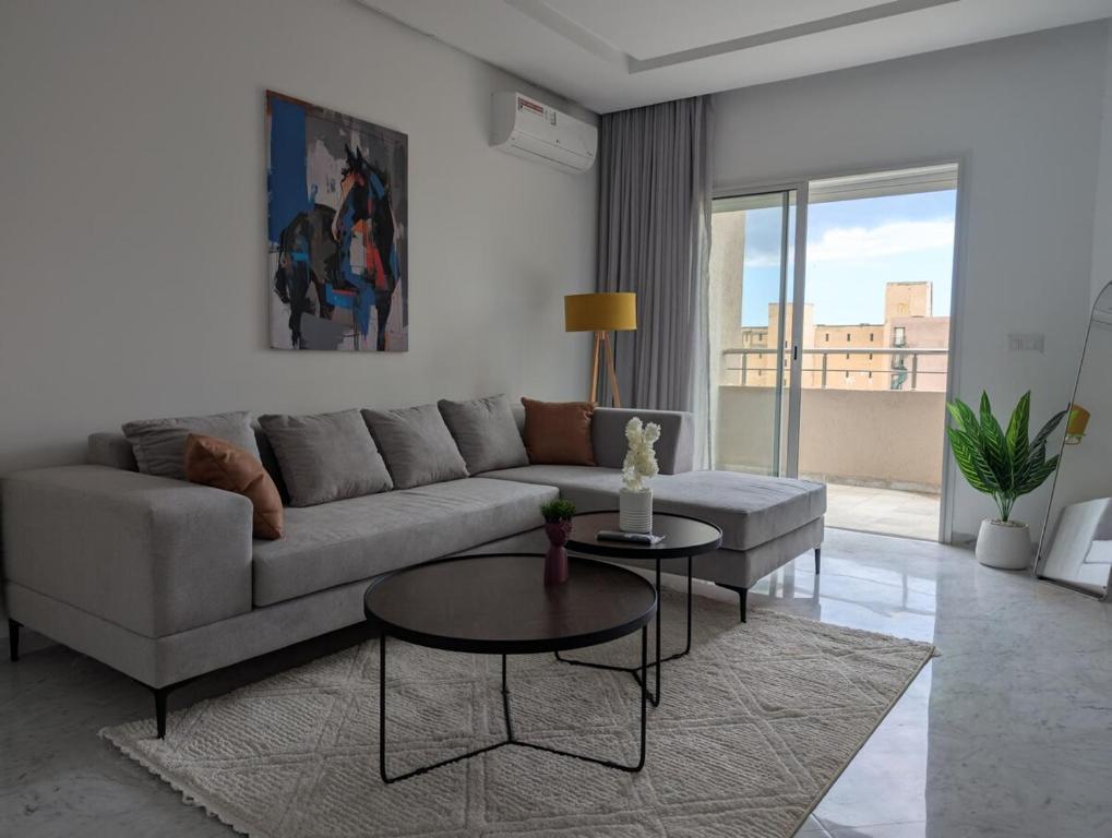 a living room with a couch and a table at Dar GAMRA Luxury apartment with sea view in Hammamet Sud