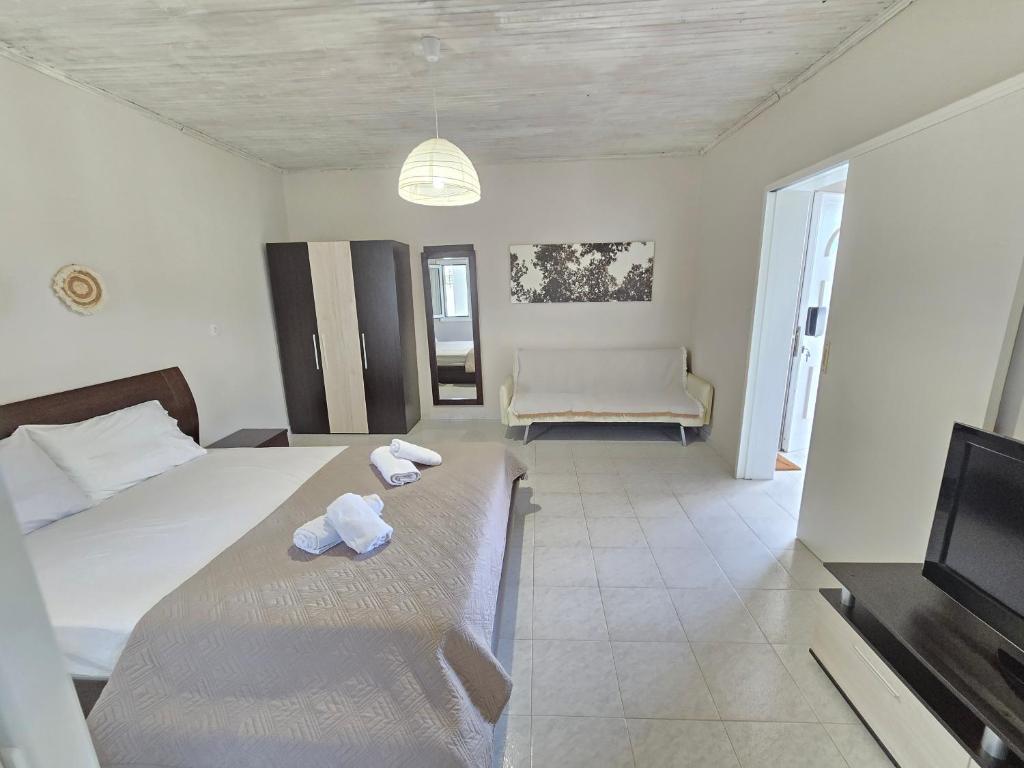 a bedroom with a bed and a tv and a couch at Casa Di Oliva 2 in Vergia
