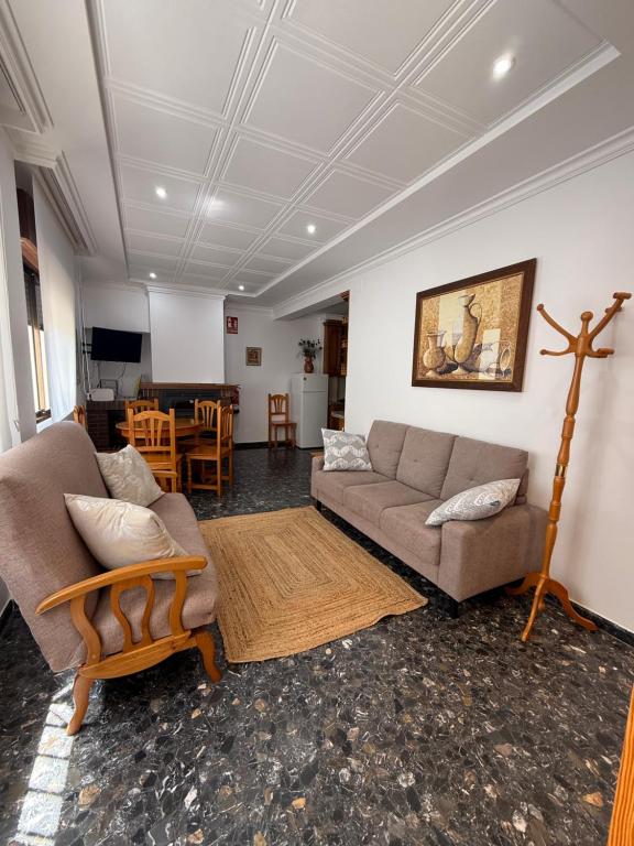 a living room with two couches and a table at Antonia Medina Relax in Cogollos de Guadix