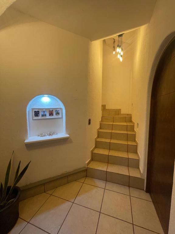 a hallway with stairs in a building with a window at Casa Quiñones in Cedro