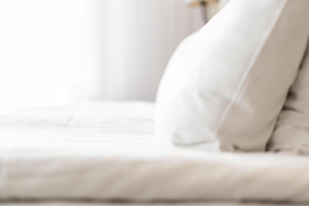 a close up of a white bed in a room at Scandic Gamla Stan in Stockholm