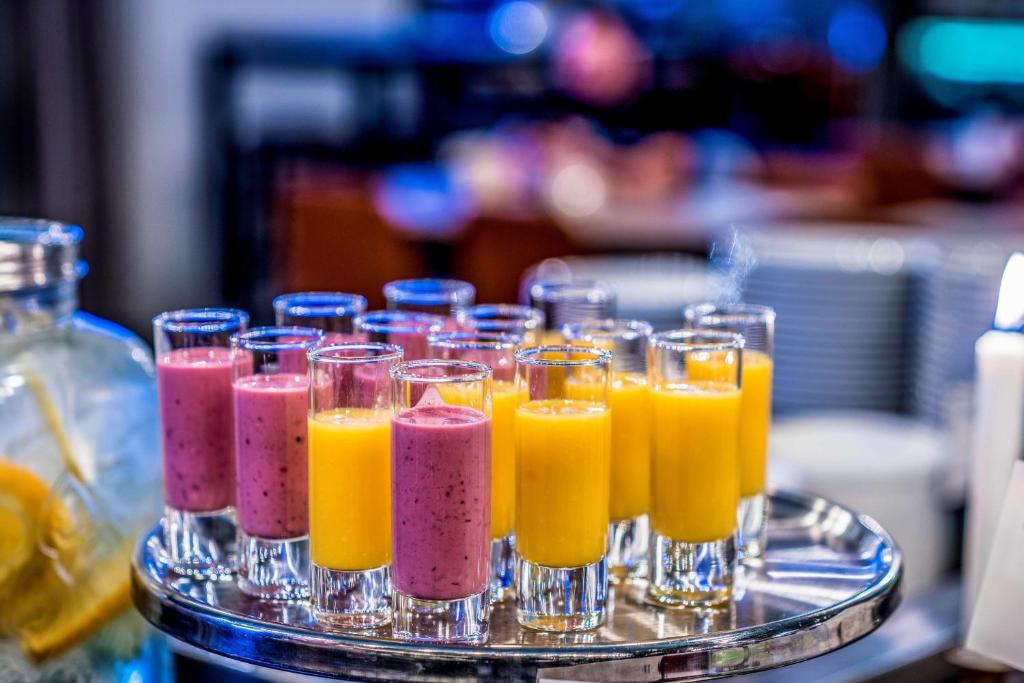 a tray of glasses filled with different colored juice at Scandic Gamla Stan in Stockholm