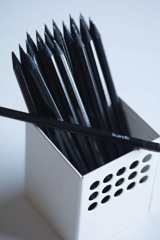 a group of black chopsticks in a white holder at Scandic Gamla Stan in Stockholm