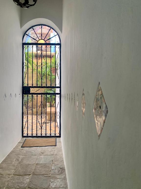 a door with a stained glass window in a room at Hostal Casa Alborada in Conil de la Frontera