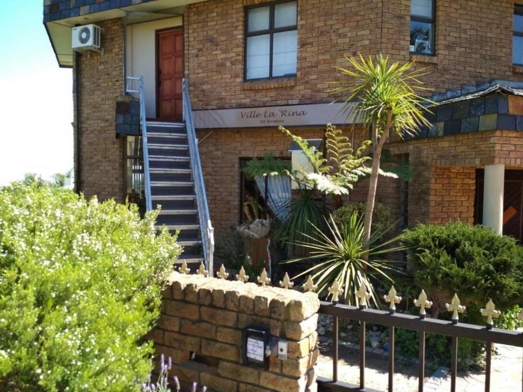 una casa de ladrillo con una escalera delante de ella en Ville la'Rina, en Ciudad del Cabo