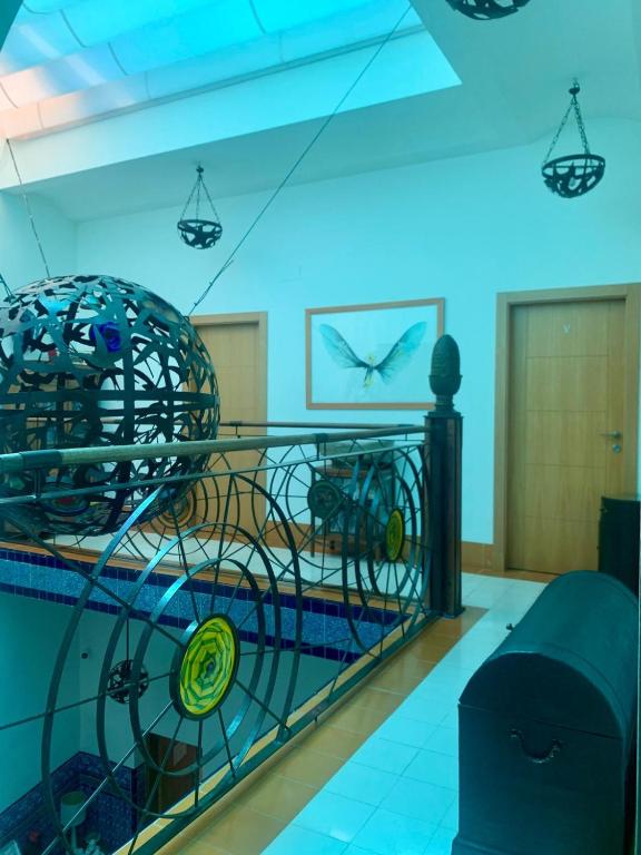 a room with a cage with a bird on the wall at Hostal Casa Alborada in Conil de la Frontera